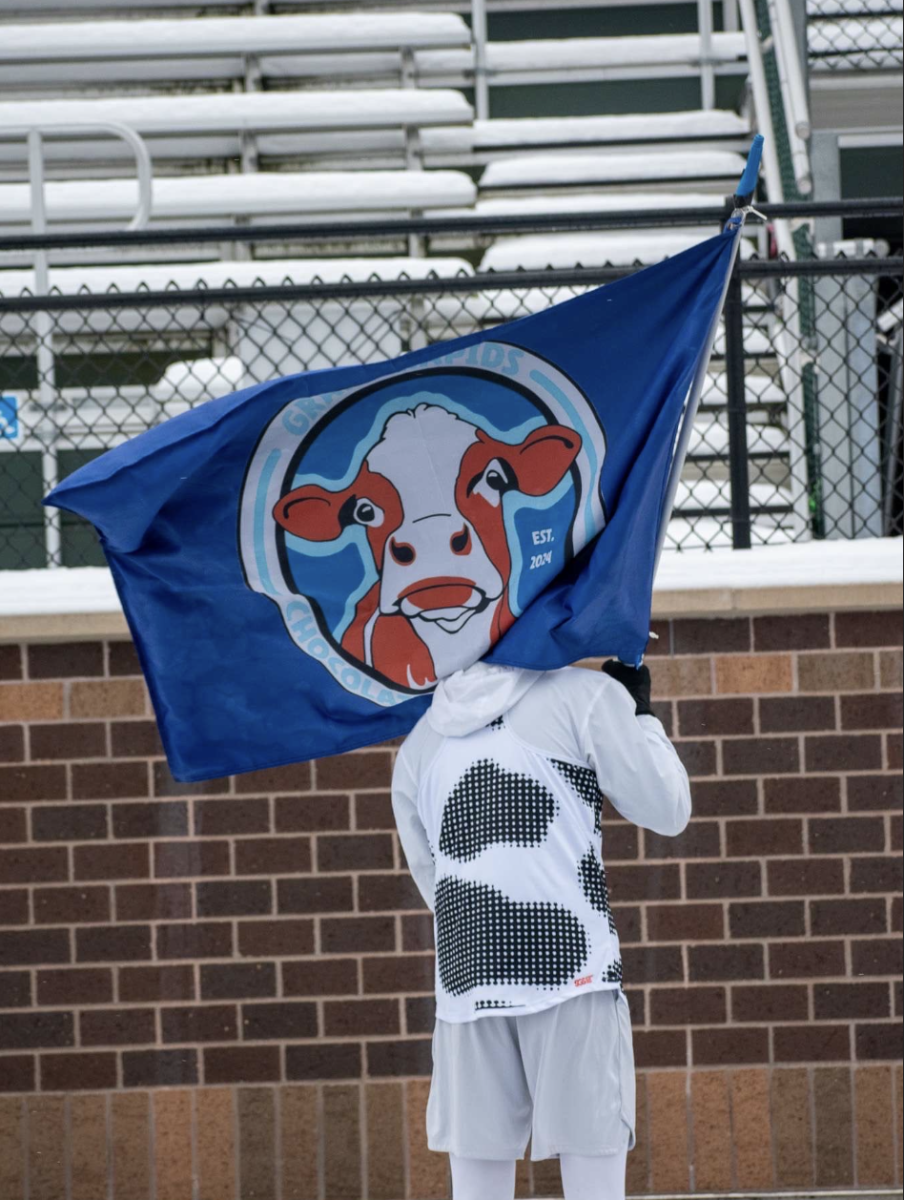 Runner Jake Barnes holding the one and only Chocolate Milk Chuggers flag.